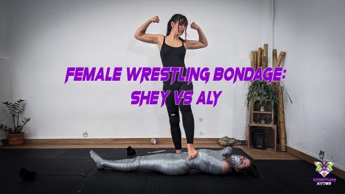 Real female wrestling bondage fight – Shey dominates and mummifies Aly in tight tape, securing a final victory pose over her defeated opponent